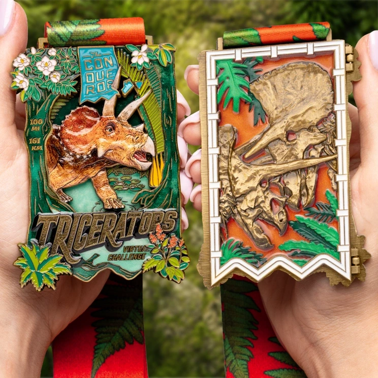Triceratops Challenge medal held in hand